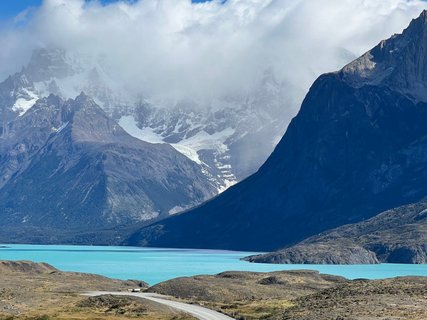 Patagonien Rundreise Selbstfahrer - Berglandschaft mit türkisfarbenem See im Vordergrund und wolkenverhüllten Gipfeln im Hintergrund