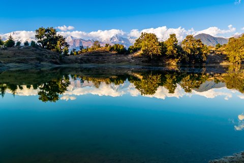 Mesmerizing view at Deoria Tal or Lake nestled in Garhwal Himalayas at  Chopta, Uttarakhand, India. This lake is a camping location for Tungnath Chandrashila hiking trail.