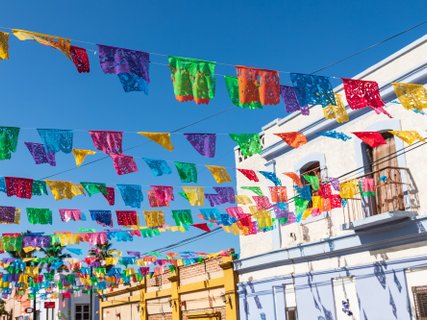 ??????????????????????????????????????????????????????? Festive colorful banners over a street in Todos Santos.