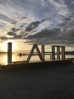 LAIM Schriftzug vor einem See bei Sonnenuntergang